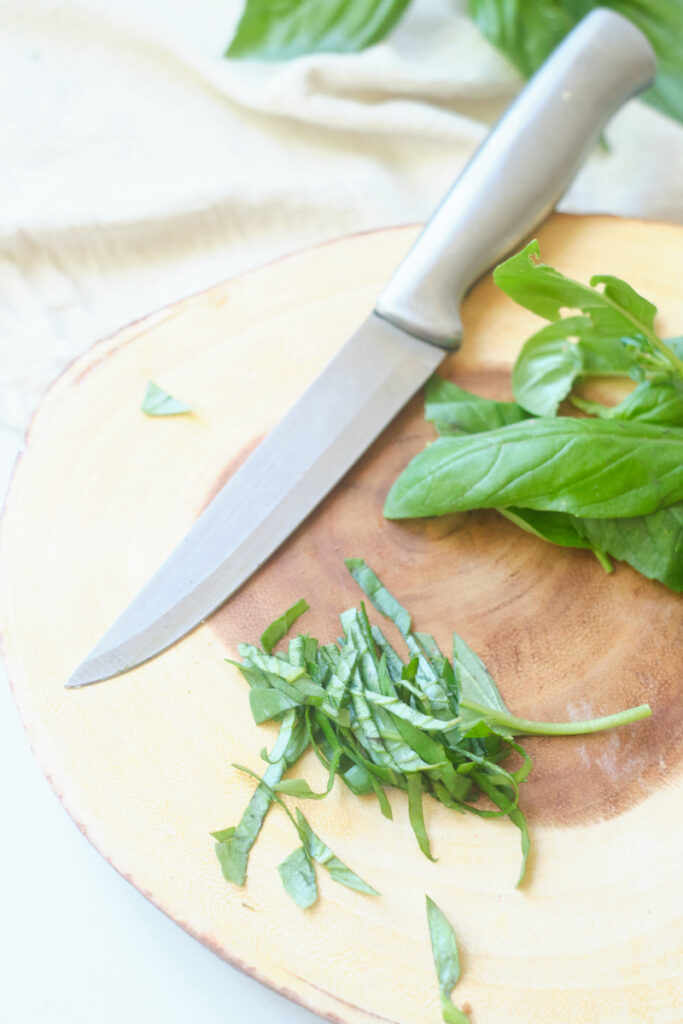 basil chiffonade on a cutting board