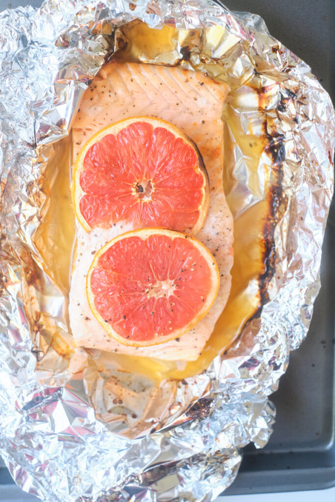 baked grapefruit salmon with grapefruit slices in a tin foil wrap