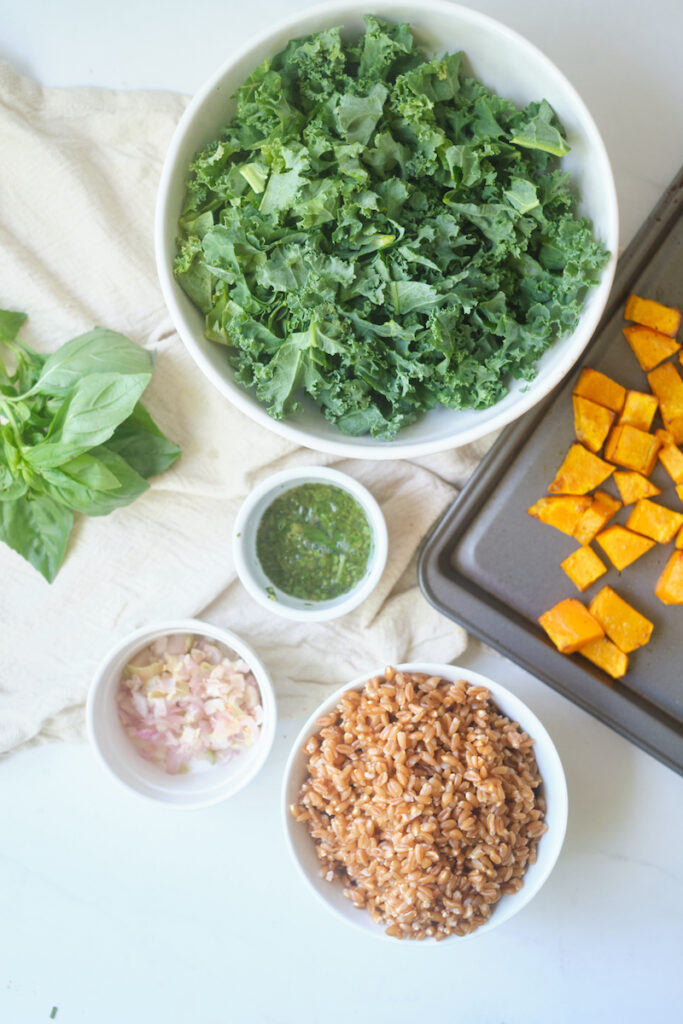 Ingredients for a kale-butternut-squash-salad on a table