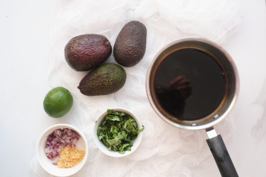 ingredients for basil guacamole with balasmic reduction on a table in advance of making