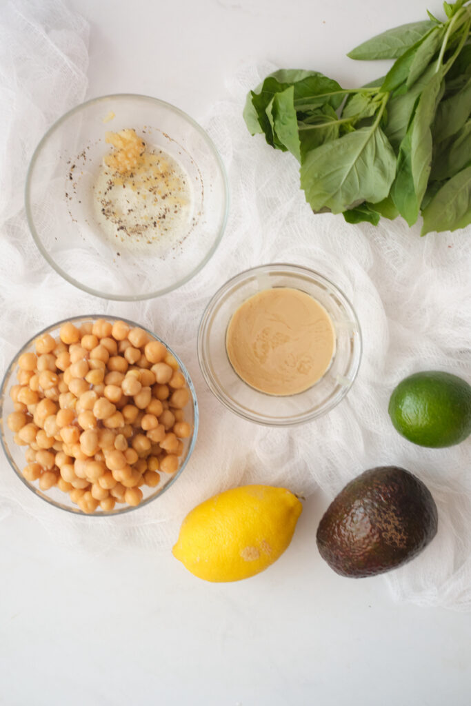 Ingredients for basil avocado hummus dip on a table