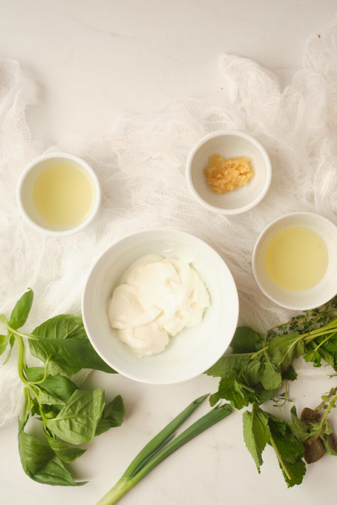 ingredients for basil green goddess dressing including fresh herbs