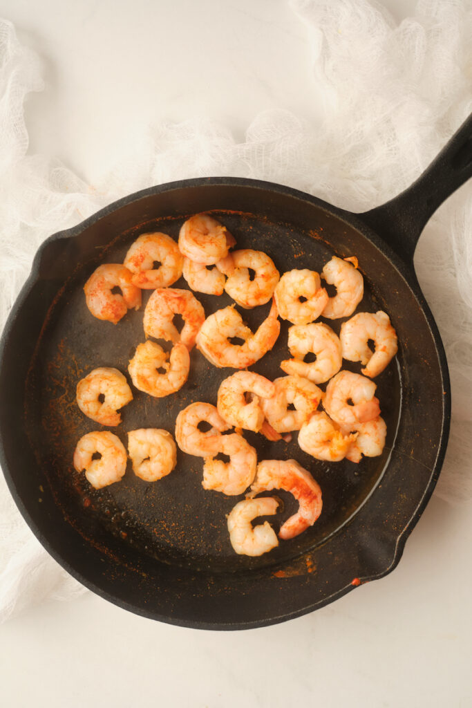 chilli shrimp sautéing in a cast iron pan