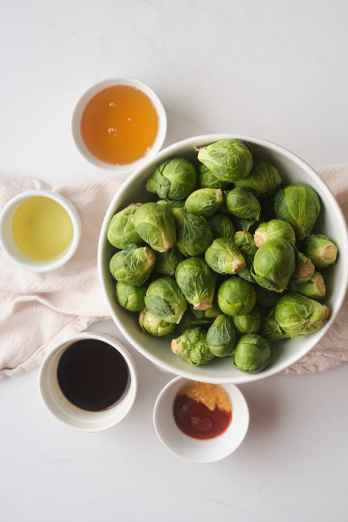 Separated ingredients for roasted sweet and spicy brussel sprouts with basil