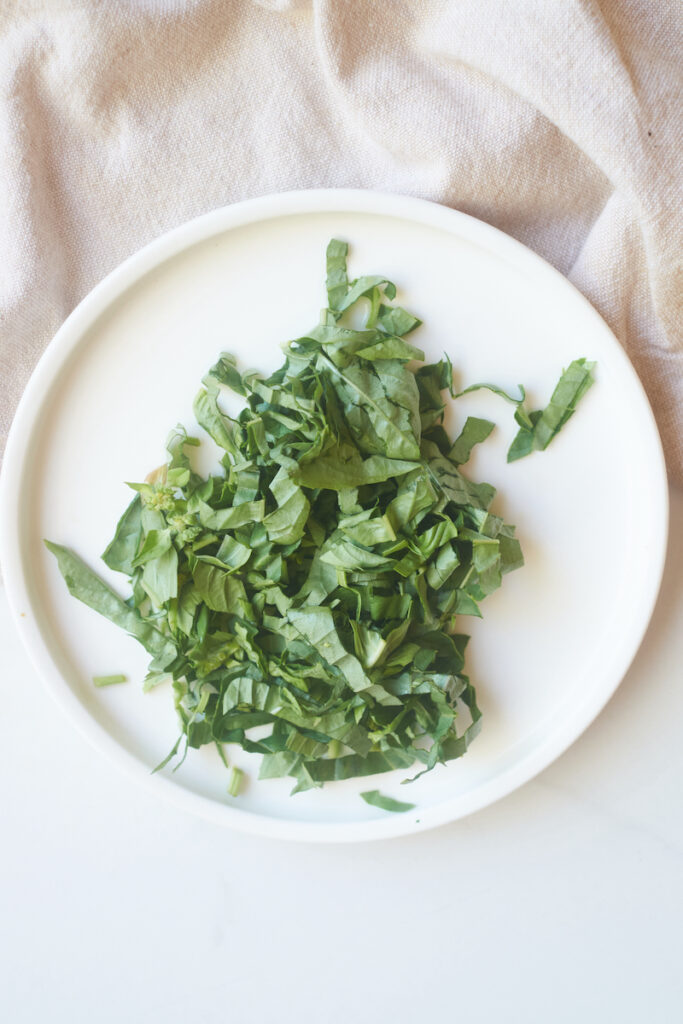 basil chiffonade on a white plate