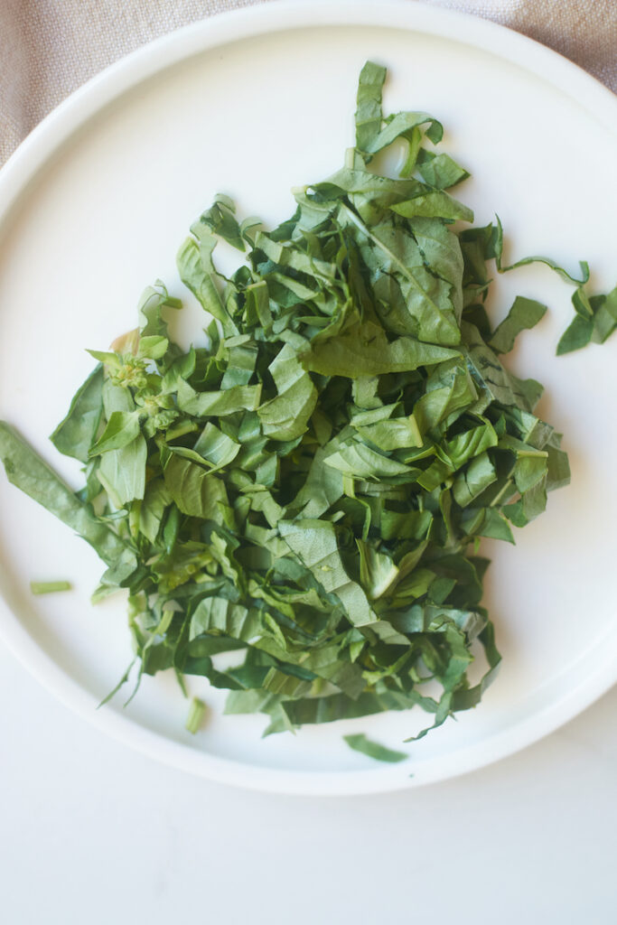 basil chiffonade on a white plate