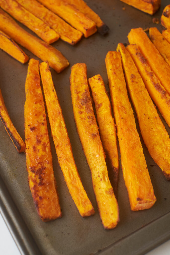 curry yam fries on a baking sheet after baking