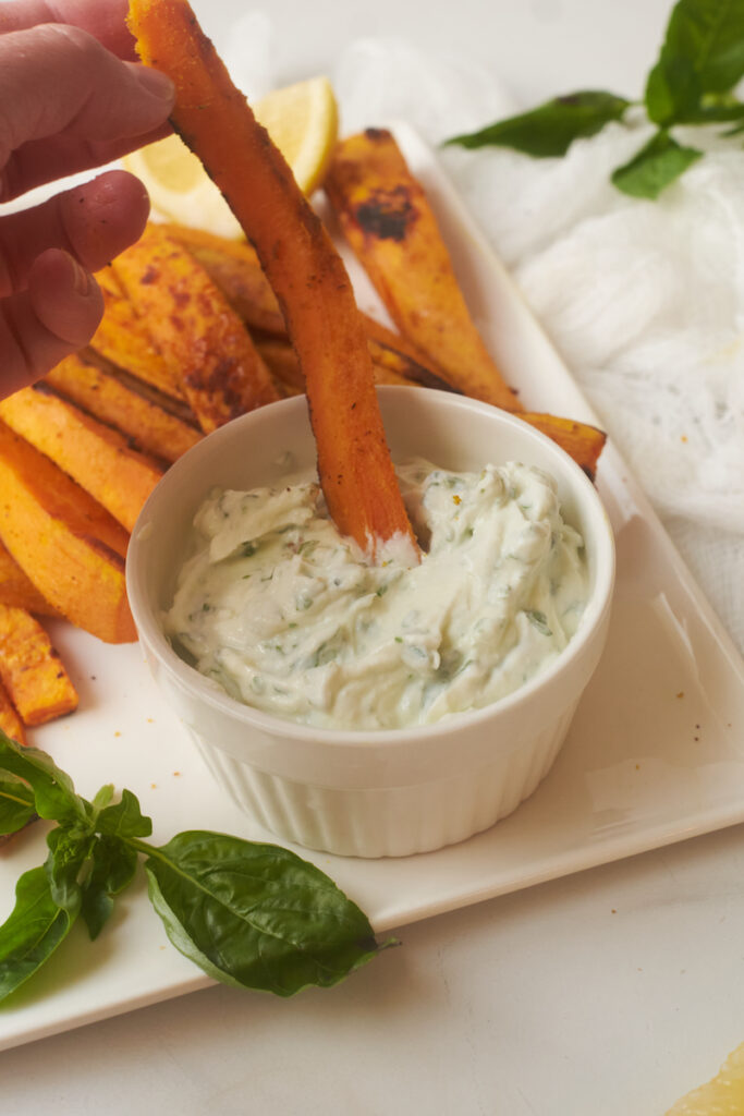 curry yam fries with basil mint yoghurt dip on a serving dish