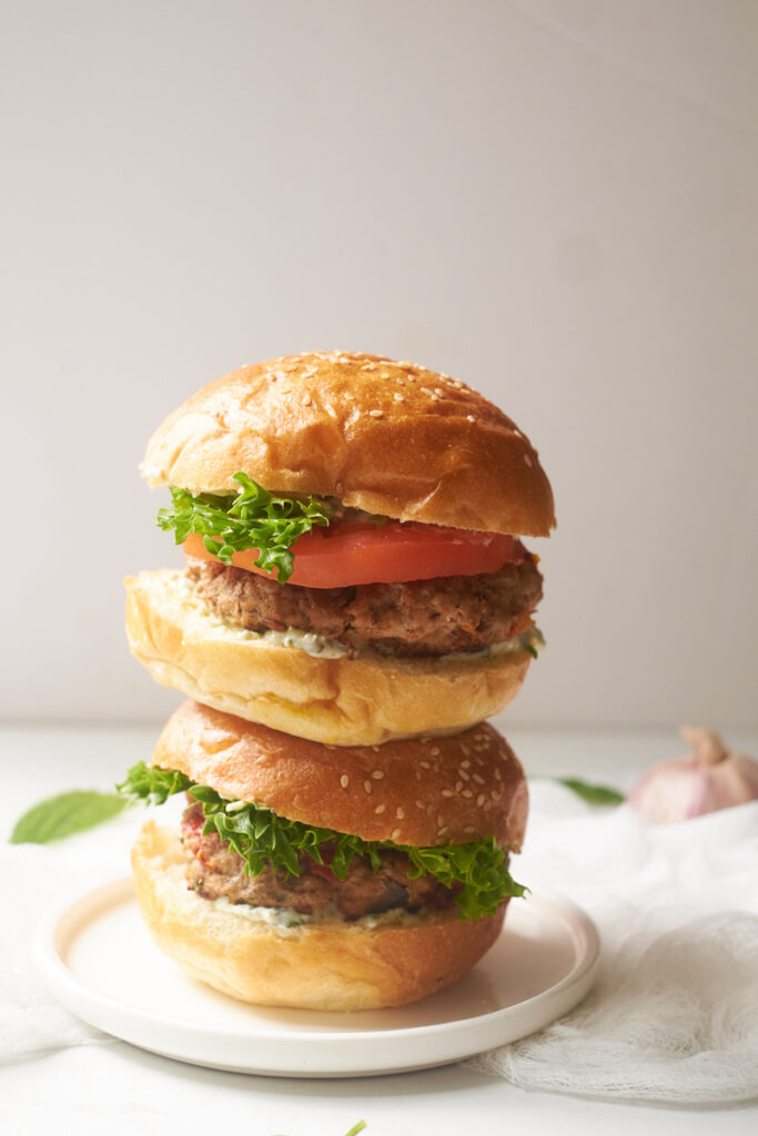 2 turkey burgers stacked on top of one another on a plate