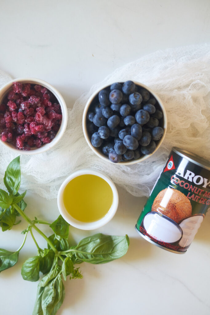 ingredients to make coconut milk ice pops flavored with fruit and basil