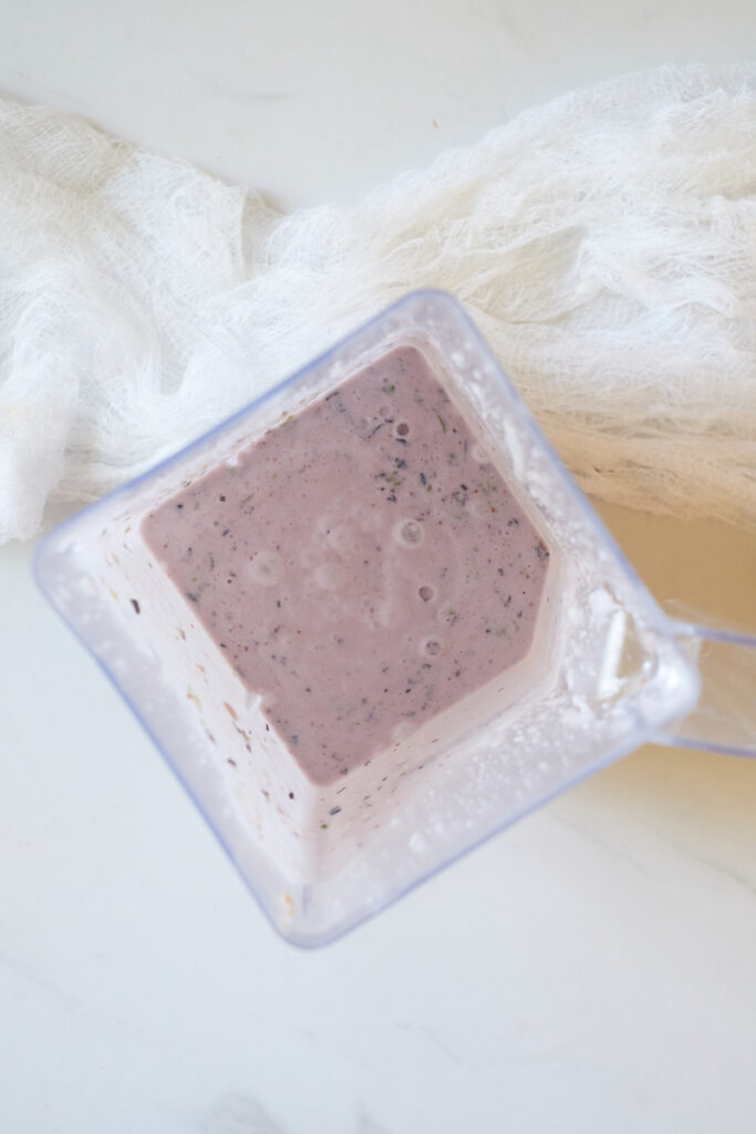 coconut milk basil and blueberry mixture in a blender