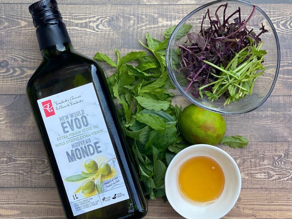 Ingredients for lime, basil stem, basil and mint salad dressing including some Mrs Burns lemon basil leaves