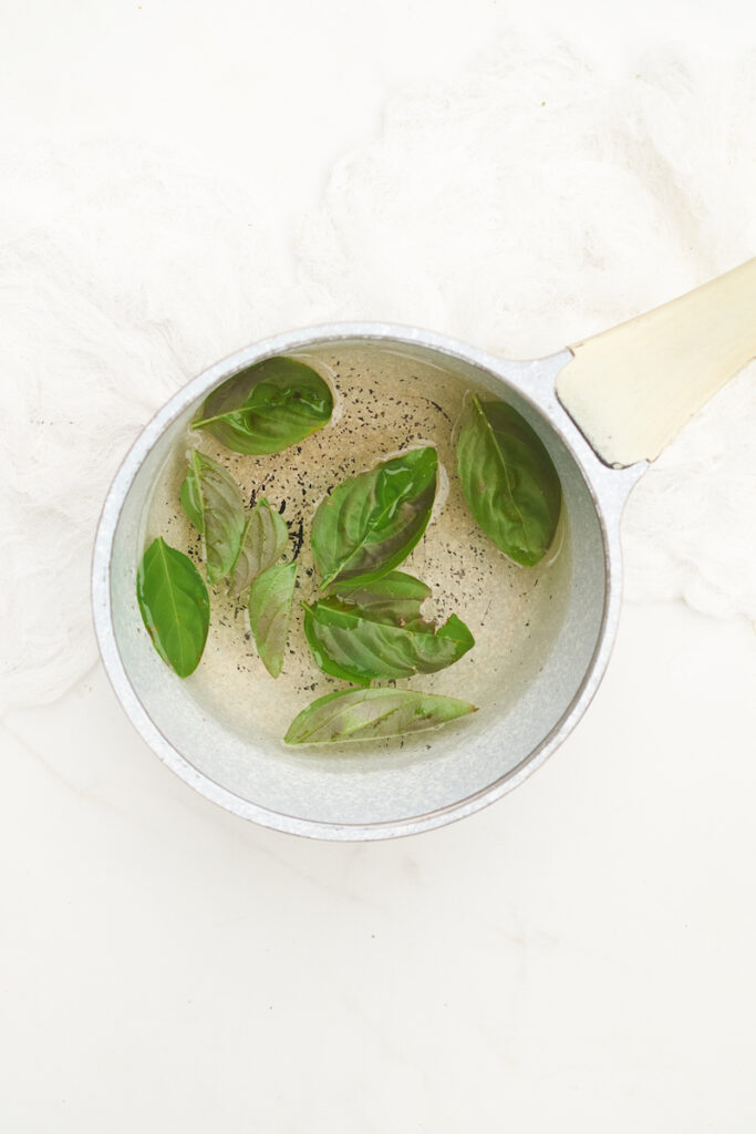 Fresh basil leaves blanching in boiling water